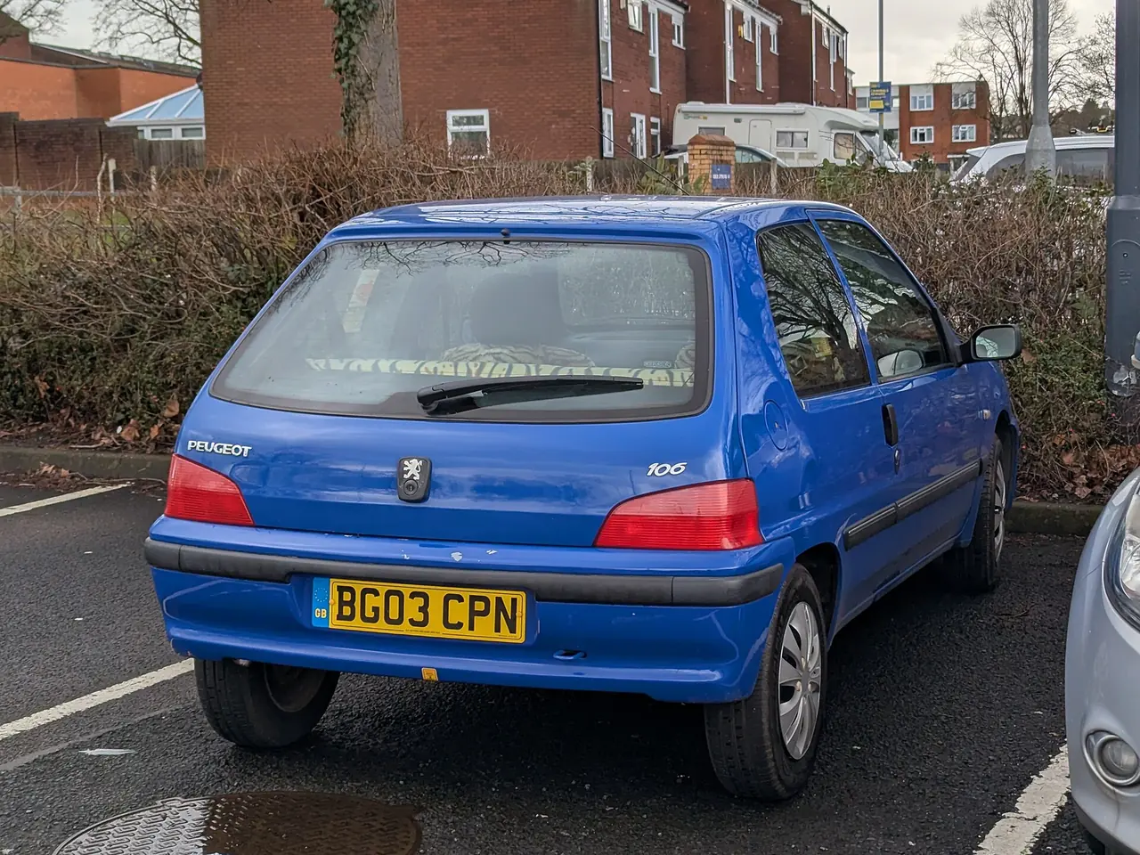 Blue 2003 Peugeot 106 seen from behind